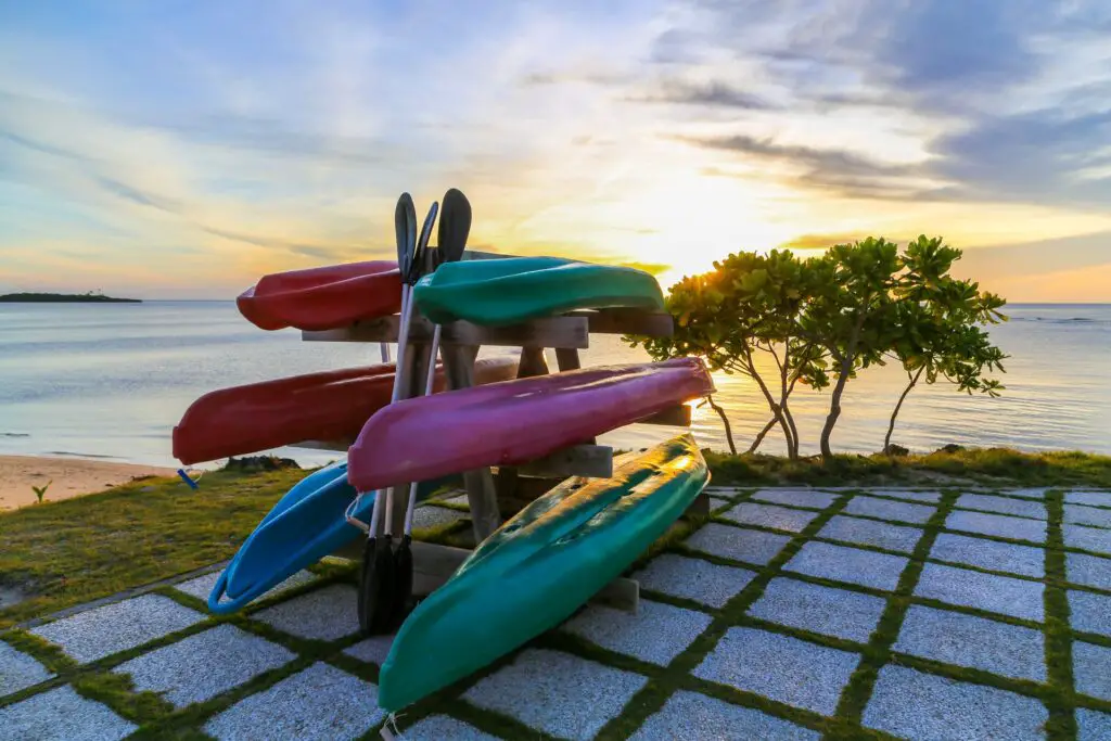 Una pila de canoas descansa en la orilla de una playa en Florida. Navegar en kayak en Miami es una forma relajante y emocionante de explorar el aire libre.